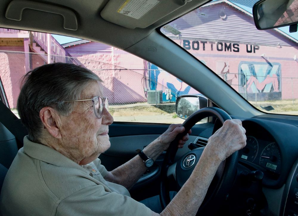 Sr. Julia Huiskamp drives past Bottoms Up, a strip club. Sr. Julia Huiskamp drives past Bottoms Up, a strip club.