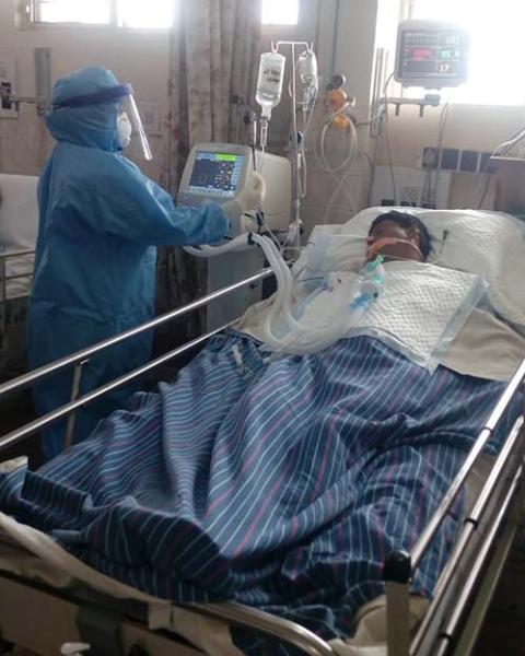 Our Lady of Charity of the Good Shepherd Sr. Monica D'silva tends to a COVID-19 patient at St. Martha's Hospital in Bangalore, India. (Courtesy of Monica D'silva)