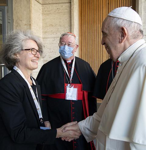 Pope Francis greets Xavière Sr. Nathalie Becquart, undersecretary of the Synod of Bishops, during a meeting with representatives of bishops' conferences from around the world at the Vatican Oct. 9, 2021. (CNS/Paul Haring)