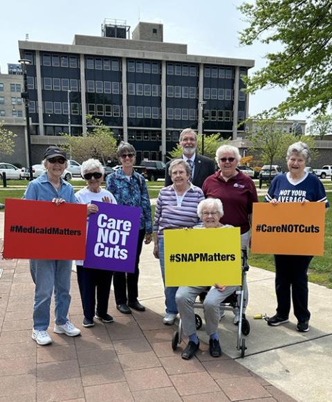 Sisters of St. Joseph of Northwest Pennsylvania stand with Mayor Joe Schember of Erie, Pennsylvania, at a "Care Not Cuts" rally opposing significant budget cuts in the debt ceiling negotiations in May. Schember spoke to the role of federal funding in the city's initiatives to expand access to housing. (Courtesy of Emily TeKolste)