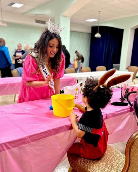 Miss District of Columbia visits with a child residing at St. Ann's Center for Children, Youth and Families during an Easter celebration at the nonprofit. (Courtesy of St. Ann's Center for Children, Youth and Families)