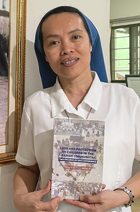 Salvatorian Sr. Ruth Baguinon shows a copy of the book Care and Protection of Children in the Parish Community: Two Decades of SPCC Experience. (Tonette Orejas)