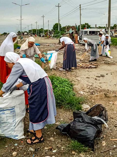 Sisters clean up the seaside in Cordova, Mactan Island, Cebu, Philippines, Aug. 31. (Courtesy of Franciscan Sisters of the Immaculate Conception of the Holy Mother of God)