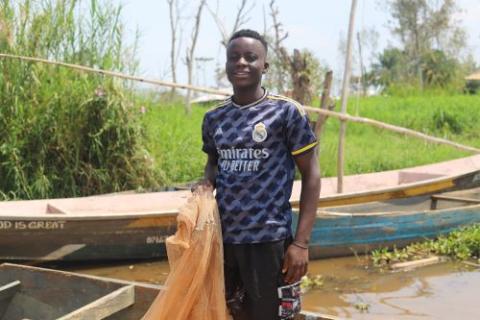  Joseph Ahadi, 17, cleans his fishing nets.