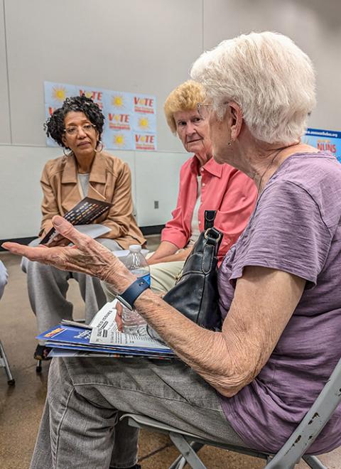 Bus riders Lisa Sharon Harper of Freedom Road (left), and Sr. Richelle Friedman (center), a member of the Sisters of Charity of the Blessed Virgin Mary, listen to a Las Vegas resident's concerns at the bus tour's Town Hall to Vote Our Future in Las Vegas Oct. 14. (Alecia Westmorland)