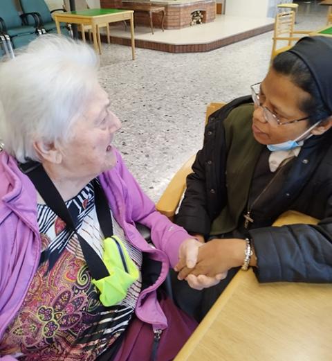 Sr. Lina Magdalina Murmu visits an elderly, sick Catholic parishioner of the St. Bartolomeo Parish and gives her Holy Communion. (Courtesy of Lina Magdalina Murmu)