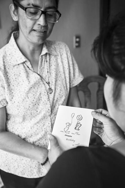 The handmade cards and stationery that young women create at Grupo Dorca is both an opportunity for them to make money as well as become engaged with one another and their craft. Here, Sr. Angélica Segoviano and a Dorca participant show one of their cards. (Courtesy of Lisa Kristine)