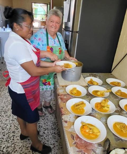 Maryknoll Sr. Dee Smith, right,  helping with the lunchtime program for resident HIV-positive people at the Hospicio Santa Maria/Proyecto Vida in Pajapita, San Marcos, Guatemala. She is seen with Sara, who is not HIV-positive but has lost relatives to HIV. (Photo courtesy of Dee Smith)