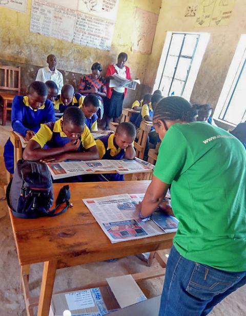 Students at Kairungu Primary School in Mwingi West, Kitui County, Kenya, use newspapers provided through the Newspapers in Education program to engage in reading and discussion. The initiative aimed to enhance literacy, strengthen teacher-student relationships, and promote awareness of child rights and protection. (Courtesy of Damaris Muthusi)