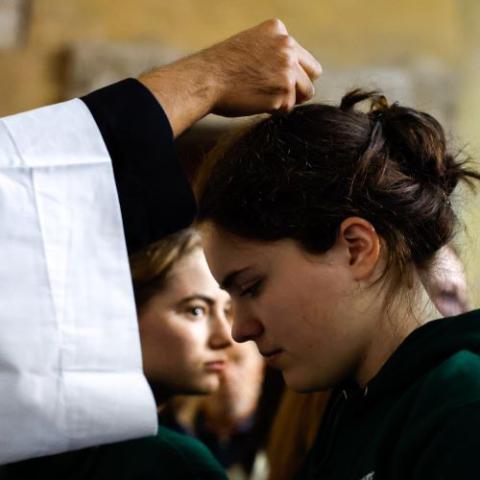 A woman receives ashes during Pope Francis' Ash Wednesday Mass at the Basilica of Santa Sabina in Rome Feb. 14, 2024. (CNS/Lola Gomez)