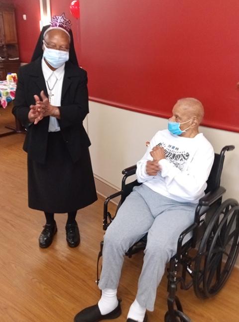 Holy Family Sr. Jean Martinez dances with one of the residents of Chateau de Notre Dame in New Orleans. (Courtesy of Jean Martinez)