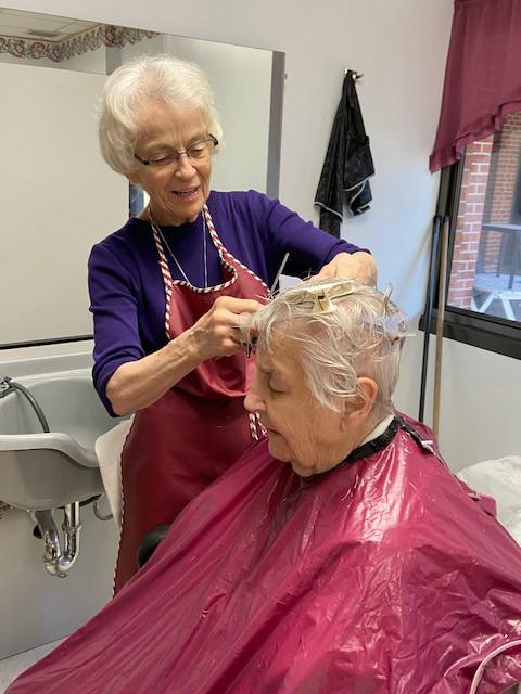 Sr. Micaela Randolph of the Benedictine Sisters of Mount St. Scholastica cuts Sr. Jeanne d'Arc Kernion's hair. (Courtesy of the Benedictine Sisters of Mount St. Scholastica)