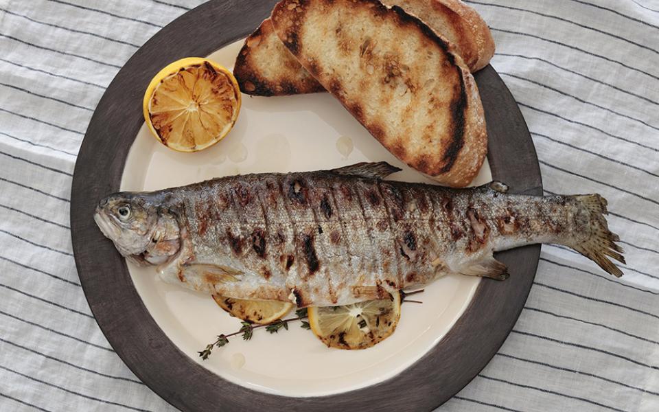 Grilled rainbow trout is accompanied by toasted bread. (CNS/Nancy Wiechec)