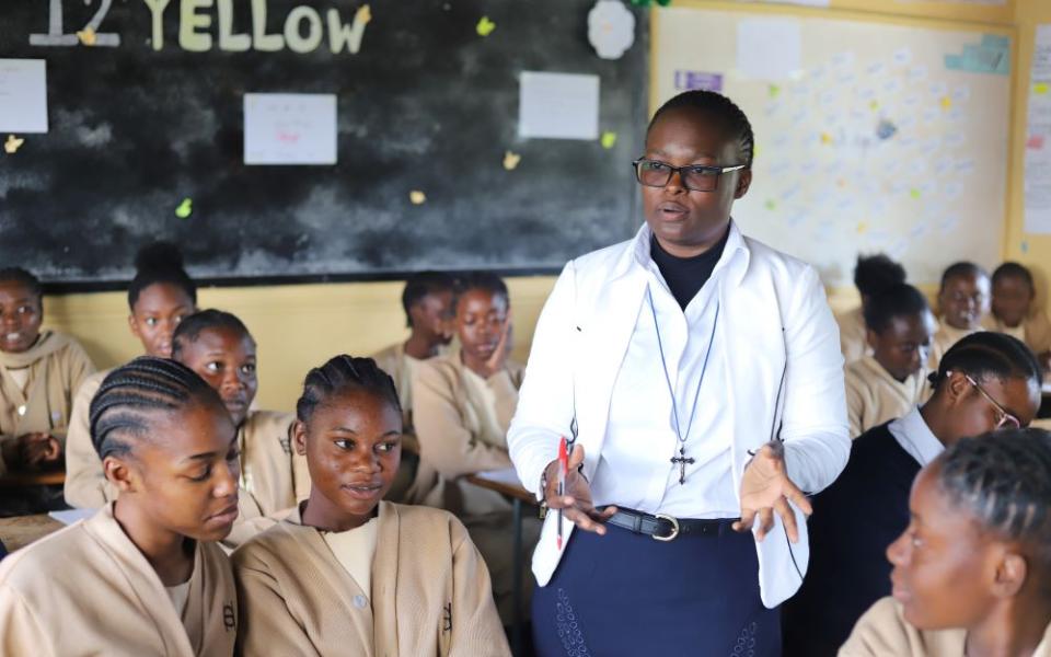 Sr. Angela Ngwenyufu, a member of the Handmaids of the Blessed Virgin Mary, interacts with her students at St. Patrick's Secondary Girls School in Lusaka, Zambia, on May 25. Through ASEC's Higher Education for Sisters in Africa program, Ngwenyufu earned a degree in education. (GSR photo/Doreen Ajiambo) 