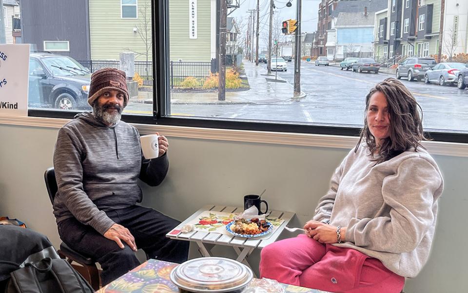 Guests Gregory Morton and Angela Rice sit in the front room of St. Joseph's Place in Schenectady, N.Y. "This is a safe haven," Morton said. "If they're open, I'm here." (Sara Foss)