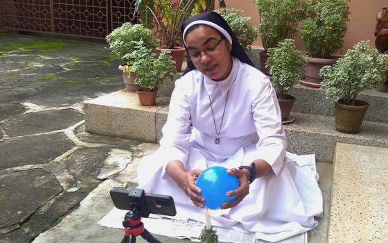 Sr. Sunitha Ruby, a member of the Congregation of Carmelite Religious, records a motivational video on her mobile using a balloon to make a point, at her convent in Thiruvananthapuram, capital of Kerala state, southwestern India. (Lissy Maruthanakuzhy)