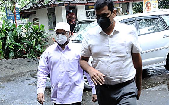 Bishop Franco Mulakkal of Jalandhar (in white hat and mask) arrives at the District and Sessions Court in Kottayam, Kerala, Sept. 16, 2020, to stand trial in a rape case against him. (Saji Thomas)