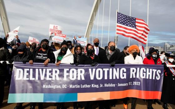 Martin Luther King III, the eldest son of late civil rights activist the Rev. Martin Luther King Jr., and his family take part in a Peace Walk on the Frederick Douglass Memorial Bridge in Washington Jan. 17.