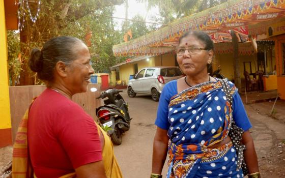 Sr. Marie Lou Barboza, left, a member of the Immaculate Heart of Mary congregation, speaks to Chandra, a migrant woman from Telangana state who now lives in Saligao, a village in Goa. (Lissy Maruthanakuzhy)