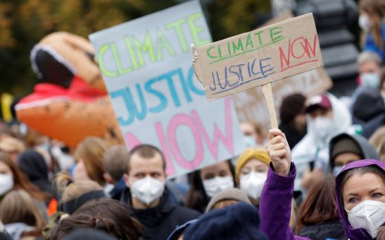 Demonstrators hold signs Oct. 22 during the Global Climate Strike of the movement Fridays for Future in Berlin. (CNS/Reuters/Michele Tantussi)