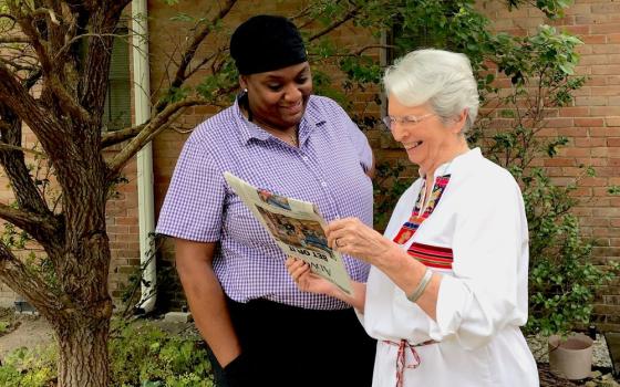 St. Joseph Sr. Dianne Fanguy (right) and St. Joseph Associate Monique Harper look at a news story that says a more stringent environmental review by the Army Corps of Engineers will delay a proposed plastics complex. (Courtesy of Dianne Fanguy)