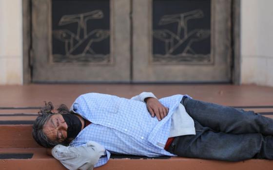 A homeless man sleeps outside Our Lady of Guadalupe Church in Austin, Texas, Sept. 3. (CNS/Bob Roller)