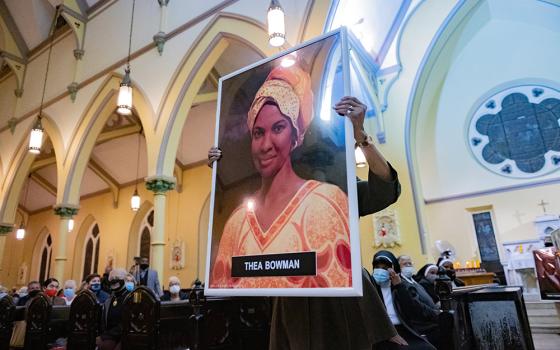 Theresa Wilson Favors, former director of the Office of Black Catholic Ministries for the Archdiocese of Baltimore, carries a portrait of Sr. Thea Bowman during an All Saints' Day Mass at St. Ann Catholic Church Nov. 1 in Baltimore. (CNS)