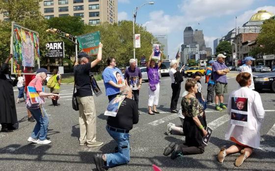 Susan Francois, in blue, stands in the intersection by the Federal Building. (Susan Whitsell)