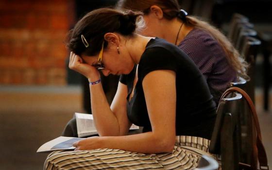 Mariana Hernandez prays during a 2018 prayer service for repentance and healing for clergy sexual abuse at Our Lady of the Brook in Northbrook, Illinois. (CNS/Chicago Catholic/Karen Callaway)