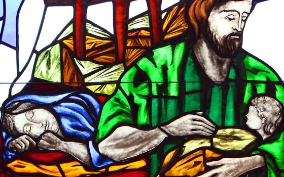 A depiction of St. Joseph cradling the infant Jesus while Mary sleeps is seen in a stained-glass window at St. Patrick Church in Smithtown, New York. (CNS/Gregory A. Shemitz)