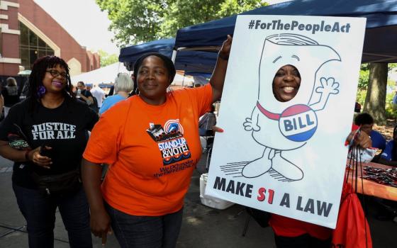 People in Atlanta advocate for the For the People Act on a June 21 stop on the Black Voters Matter organization's Freedom Ride for Voting Rights. Organizers said they planned the tour to recall the Freedom Rides, a series of protests against segregation b