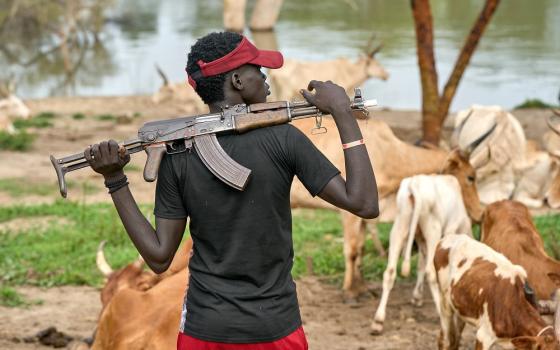 A cattle keeper holds an assault rifle Sept. 1 in Mogok, South Sudan.