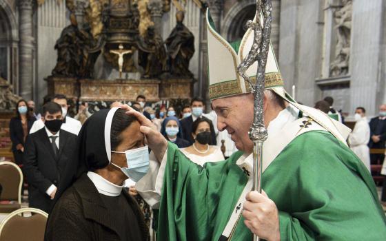 Pope Francis blesses Sister Gloria Cecilia Narváez Argot, a member of the Franciscan Sisters of Mary Immaculate, at the end of Mass in St. Peter's Basilica at the Vatican Oct. 10, 2021. The sister, a missionary from Colombia, was kidnapped in Mali in 2017