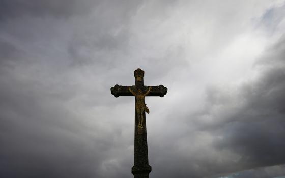 A cross is silhouetted outside a Catholic church Oct. 5 near Nantes, France. (CNS/Reuters/Stephane Mahe)