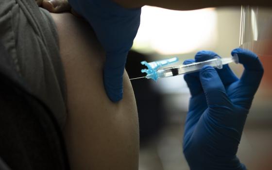 A health care worker at Catholic Charities in the Brookland neighborhood of Washington, D.C., administers the Johnson & Johnson COVID-19 vaccine May 18, 2021. (CNS/Tyler Orsburn)