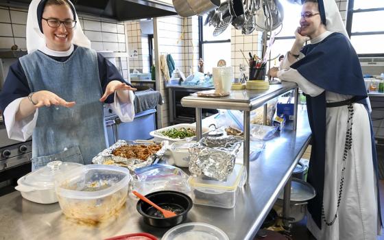 Sister Madeleine, left, works in the kitchen as she laughs with Sister Monica Marie on Jan. 15 at St. Anthony's Convent of the Sisters of Life in Catskill, New York. (CNS/The Evangelist/Cindy Schultz)