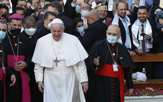 Pope Francis walks next to Chaldean Patriarch Louis Sako of Baghdad, right, as he arrives to celebrate Mass at the Chaldean Catholic Cathedral of St. Joseph in Baghdad March 6, 2021. (CNS/Paul Haring)