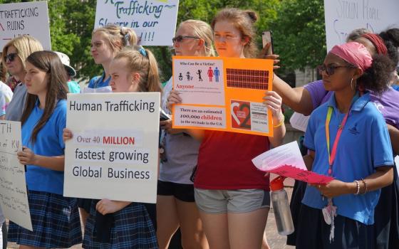 Young people demonstrate with signs in favor of combating human trafficking 