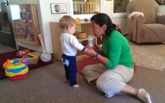 Sr. Nodelyn Abajan interacts wih a baby at a campus child care center in San Francisco in February 2014. She said she's grateful for the trust and sacred nature of working with babies and families.  (Courtesy of Nodelyn Abajan)