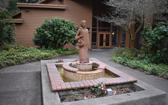 A statue of St. Placid welcomes visitors and guests at the entrance of St. Placid Priory, Lacey, Washington. (Julie A. Ferraro)