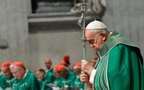Pope Francis prays while holding a crosier during Mass in St. Peter's Basilica at the Vatican Oct. 29, 2023, marking the conclusion of the first session of the Synod of Bishops on synodality. The second session of the Synod on Synodality takes place at the Vatican Oct. 2-27, 2024. (CNS/Vatican Media)
