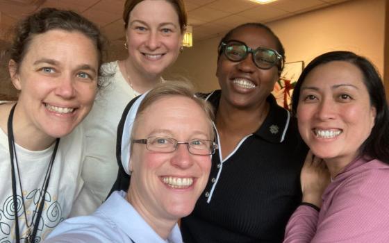 Sr. Kathryn Press, center, poses with current and previous members of the Giving Voice Core Team. They are, from left, Srs. Melissa Camardo, Erin McDonald, Chioma Ahanihu and Thuy Tran. (Kathryn Press)