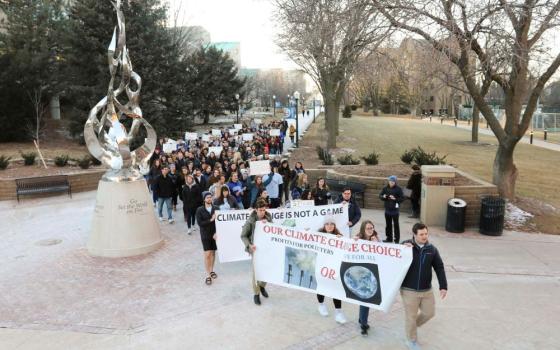 People rally at Creighton University in Omaha, Nebraska, Feb. 20, 2020, calling for the Jesuit-run school to fully divest from fossil fuels. In January 2021, the university announced it plans to phase out all investments in fossil fuels from its $587 million endowment within the next 10 years and target new investments in sustainable energy. (CNS/Courtesy of Emily Burke)