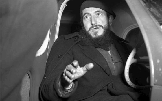 Pierre, shown in black and white photo, gets into car. 