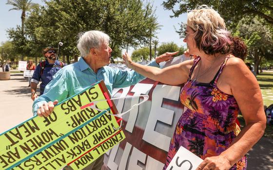 A pro-life protester and a supporter of legal abortion argue outside the Arizona State Capitol in Phoenix as the state Senate votes to repeal its near total ban on abortion May 1. (OSV News/Reuters/Liliana Salgado)