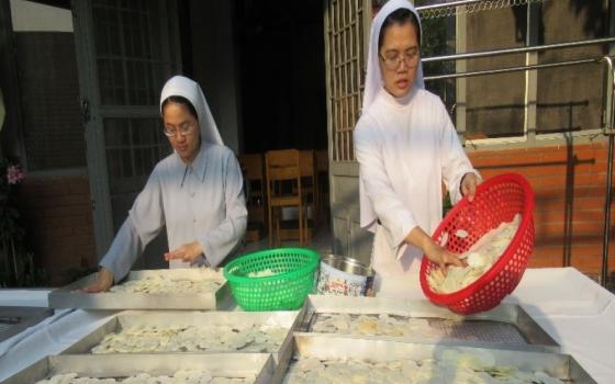 Sisters make Communion wafers.