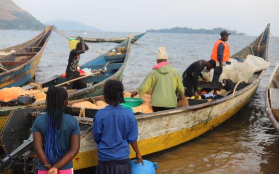 Young women on the shores of Lake Victoria in western Kenya are buying fish as boats return from fishing on July 17. The majority of girls as young as 12 say they have been sexually exploited by fishermen as they try to sustain or improve their livelihoods. (GSR photo/Doreen Ajiambo) 