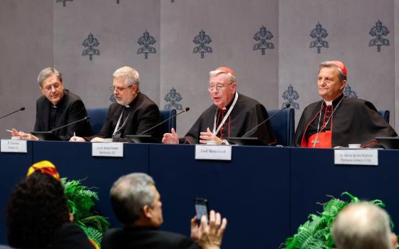 Members of the General Secretariat of the Synod, from left, Msgr. Riccardo Battocchio and Jesuit Fr. Giacomo Costa, both special secretaries for the synodal assembly; Cardinal Jean-Claude Hollerich, relator general of the synod; and Cardinal Mario Grech, secretary-general of the synod, attend a news conference at the Vatican Oct. 26. (CNS/Lola Gomez)