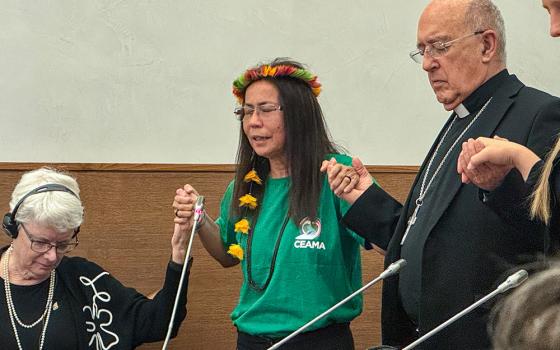 Franciscan Catechist Sr. Laura Vicuña Pereira Manso, center, leads a prayer Oct. 4 after a panel on synodality and ministry of women at Pope Pius XI Hall in Rome. Manso said tending to duties that would normally be performed by a deacon are part of daily life for some women religious since there are few pastoral workers in the remote region of the Amazon where she serves. (GSR photo/Rhina Guidos)