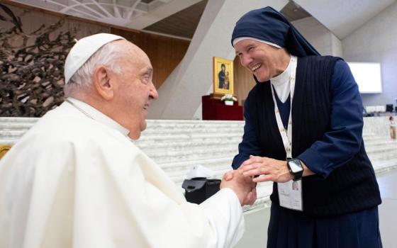 Pope Francis greets Sister Chantal Desmarais, a member of the Sisters of Charity of St. Mary and a synod delegate from Canada, in the Paul VI Audience Hall at the Vatican Oct. 4. (CNS/Vatican Media)